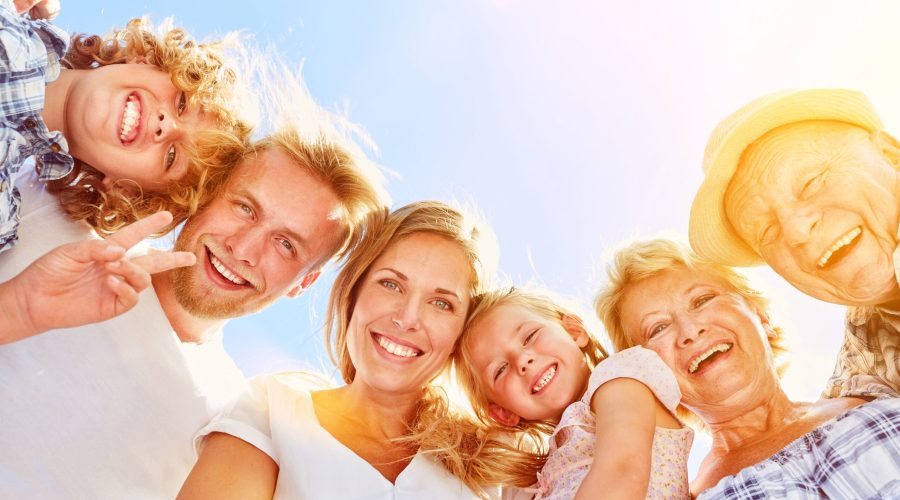 Happy laughing family with children and grandparents together in summer